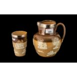 Doulton Lambeth Stoneware Ale Jug and Beaker, both with hallmarked silver rims,