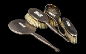 Three Edwardian Silver Hair Brushes with a matching hand mirror (4)