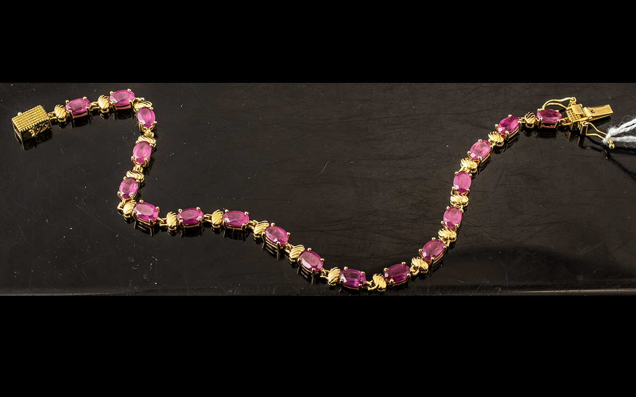 Ruby Tennis Bracelet, a line of oval cut rubies, red with a deep pink tone, making an unusual,