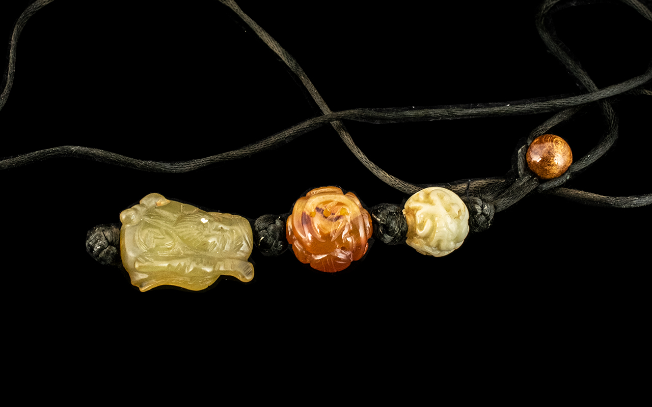 Chinese Jade Toggle of Hotei, with two carved agate beads