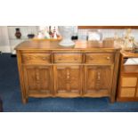 Ercol Dresser of Typical Style with three frieze drawers above cupboard space, 34 inches (app.