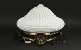 Moulded Opaque White Glass Ceiling Lamp, with a copper finished mask mount, suspended on chains.