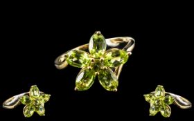 Peridot Flower Cluster Ring, five oval, luscious green peridot 'petals' totalling 2.5cts, surround a