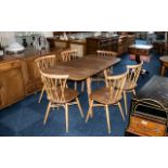 An Ercol Drop Leaf Dining Table, of typical form, together with six dining chairs.