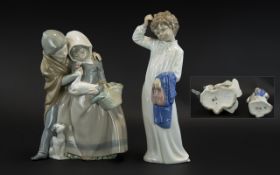 Pair of Nao Figures, comprising: boy and girl with a duck and puppy, measures 9.