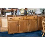 Ercol Dresser comprising two frieze drawers above three cupboard spaces; 31 inches (app.77.