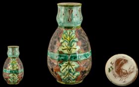 A Della Robbia Vase, by Anna Smith, potter John Fogo. Depicting leaf design, full marks to base,