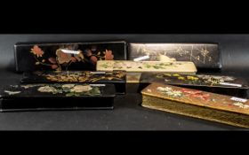 Seven Victorian Papier Mache Glove Boxes decorated with flowers and figures;