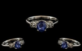 Ladies 9ct White Gold Attractive and Petite Diamond and Sapphire Set Ring, The Sapphire Flanked to