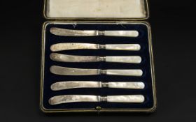 Boxed Set of Six Mother of Pearl Handled Fruit Knives with silver ferrules,