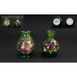 Moorcroft Pair of Tubelined Small Vases 'Orchids' Pattern on a green ground;