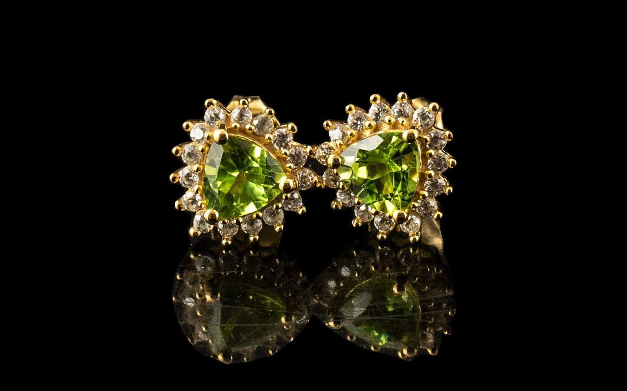 Peridot Trillion Halo Stud Earrings, trillion cut solitaire peridots, each of .75ct, set within a
