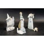 A Collection of 4 Lladro Porcelain Pieces first is a girl holding a pig,