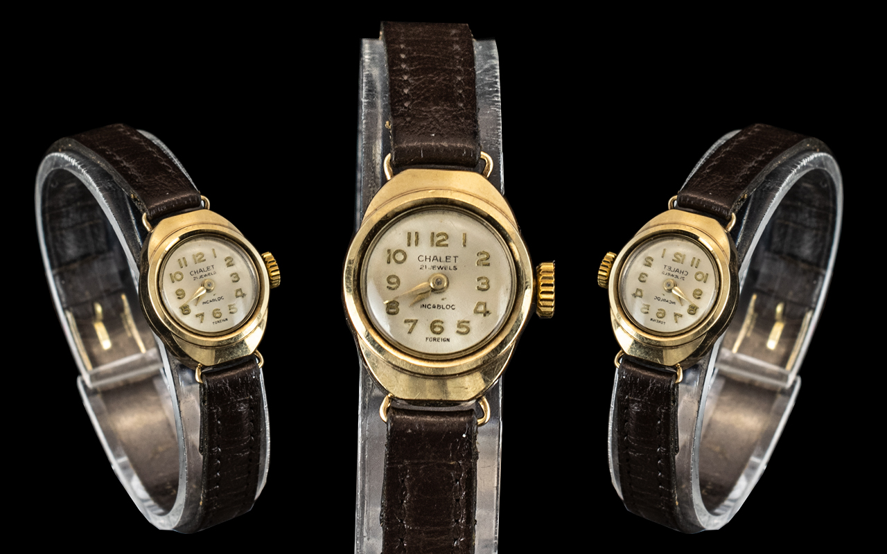 A Ladies Wristwatch Dial Mark Chalet 9ct Gold Case on a leather strap.