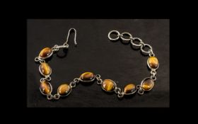 Silver Bracelet Set With Tigers Eye Cabochons, a vintage bracelet, set with nine tigers eye stones,