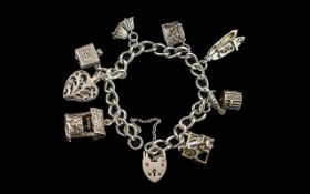 A Vintage Sterling Silver Charm Bracelet Loaded with 8 Sterling Silver Charms.