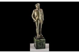 Russian Bronzed Figure of Lenin, square base with Russian script, raised on a green marble socle.