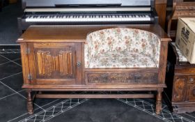 A Mid 20th Century Oak Telephone Seat, with drawer and cupboard space, raised on turned supports,