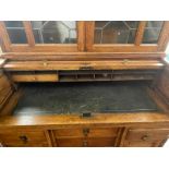 A Small Golden Oak Tambour Fronted Fitted Roll Top Desk, with a matching leaded glass cupboard top,