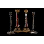 A Pair of Ruby Glass Candle Holders, gilt painted ruby glass supports, with metal mounts.