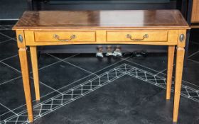 A Yew Wood Console Table with tapering legs and two drawers to the front.