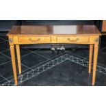 A Yew Wood Console Table with tapering legs and two drawers to the front.