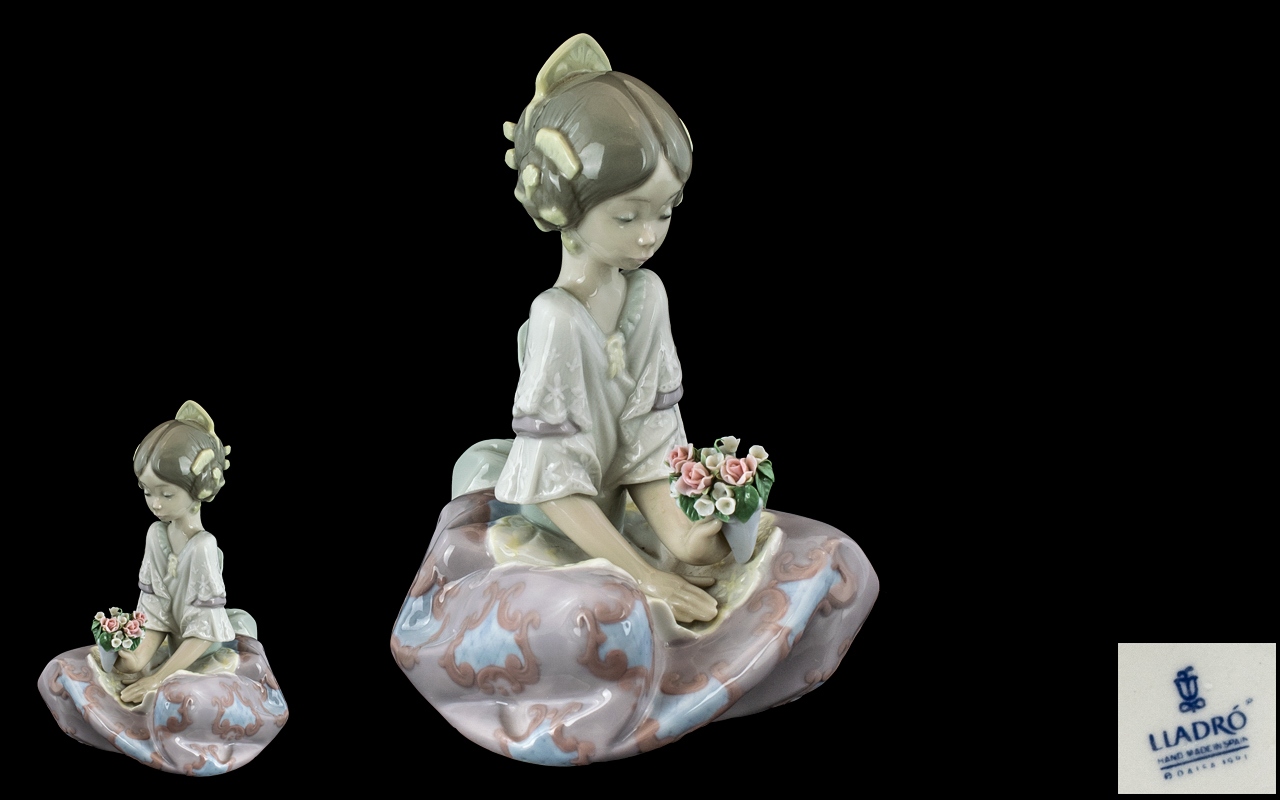 Lladro Figurine 'Serene Valencia' No. 5867 (retired), of a seated girl holding a posy.