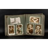 An Old Postcard Album containing an assortment of old postcards,