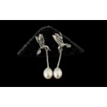 Cultured Fresh Water Pearl 'Bird in Flight' Drop Earrings, each solitaire pearl suspended from a