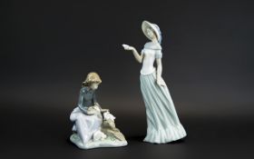 Two Nao Figures, comprising a 7'' tall figure of a seated girl with three rabbits; together with a