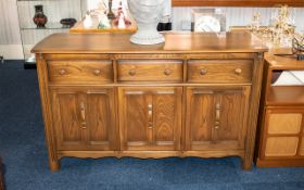 Ercol Dresser of Typical Style with three frieze drawers above cupboard space, 34 inches (app.85cms)