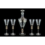 A Modern Glass Decanter Set comprising of a decanter of tapering form and four glasses with gilt