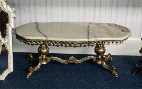 Onyx Topped Coffee Table of shaped form, raised on a gilt metal base.