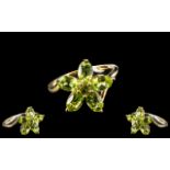 Peridot Flower Cluster Ring, five oval, luscious green peridot 'petals' totalling 2.5cts, surround a