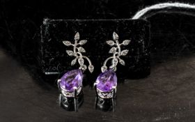 Amethyst and Diamond Drop Earrings, two solitaire pear cut amethysts of 2.75cts each and of rich