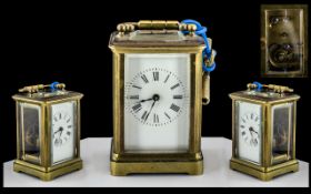 A Miniature Carriage Clock of typical form, enamel dial, Roman Numerals, visible escapement.