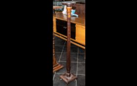 A Mahogany Edwardian Turned Torchere Stand, terminating on a square base. 52" high.