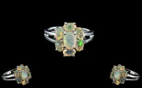 Opal Seven Stone Cluster Ring, size N, six oval cut, facetted opals surrounding a further,