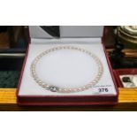 Elegant Set of Balanced Cultured Pearls of Lustrous Colour by Temples, In Red Leather Fitted Box.