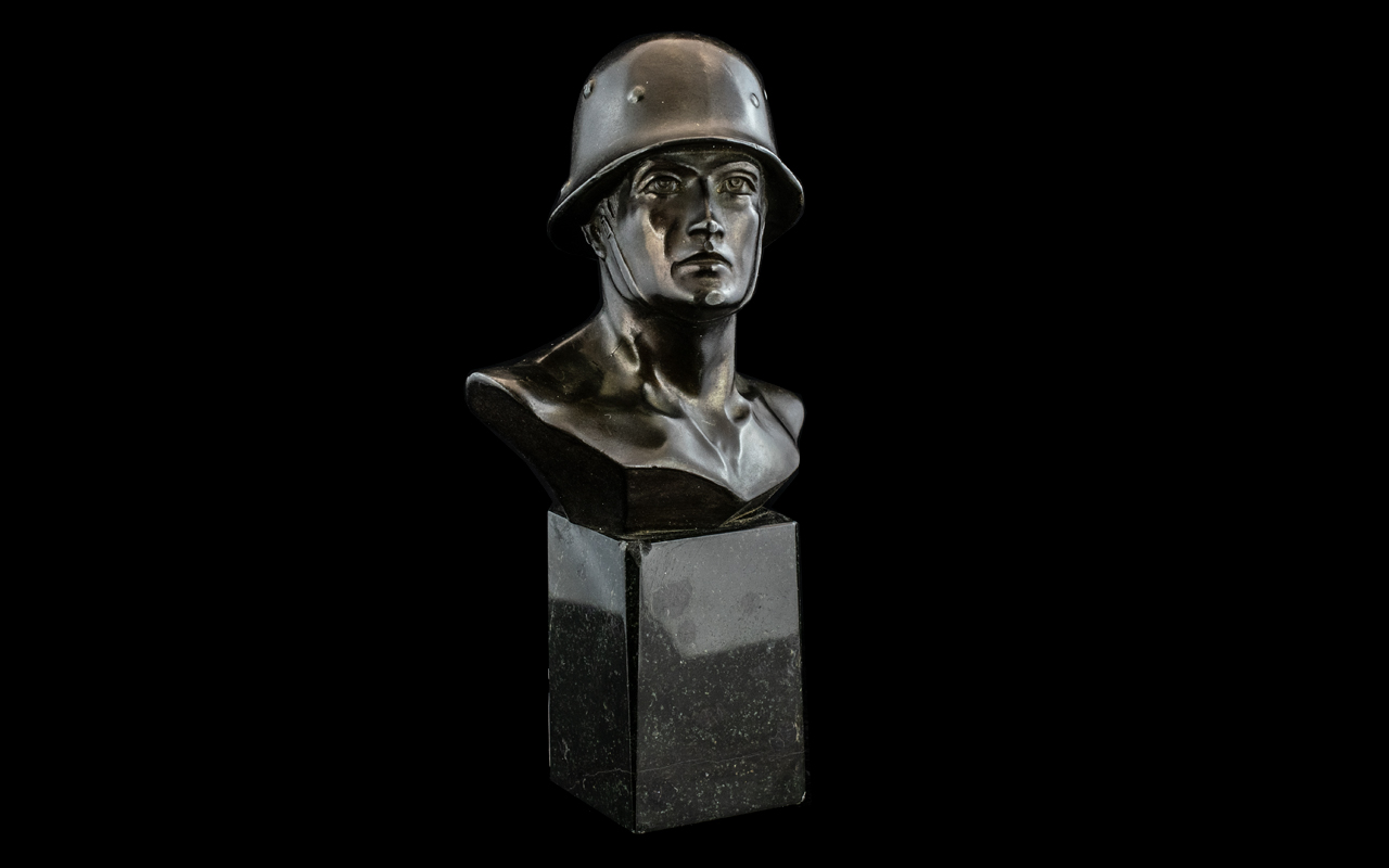 Small Bronzed Metal German Figure of a Helmeted Soldier In an Heroic Pose,