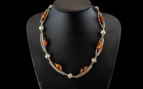 A Modern Design Silver and Amber Necklace - tubular and bauble links with Amber spacers. Length