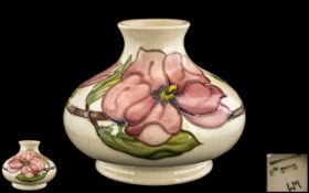 Moorcroft Vase 1950-86, Pink Magnolia pattern, pale cream ground with pink floral and leaf design.