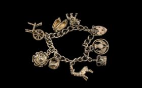 Silver Charm Bracelet, a heavy bracelet loaded with some interesting charms and a heart shaped