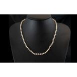 A Single Strand 16 inch Pearl Necklace with 9ct gold clasp.
