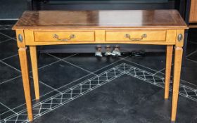 A Yew Wood Console Table with tapering legs and two drawers to the front. Measures 42'' wide x