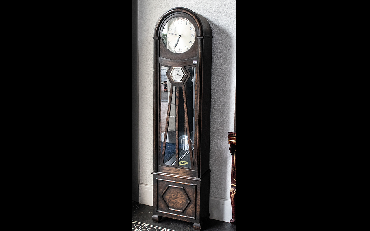 An Art Deco Long Cased Clock with silver dial, with Arabic numerals,