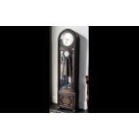An Art Deco Long Cased Clock with silver dial, with Arabic numerals,