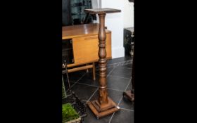 A Late Victorian Mahogany Pedestal with a turned column terminating on a stepped square base.