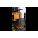 A Late Victorian Mahogany Pedestal with a turned column terminating on a stepped square base.