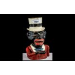 Cast Iron Money Bank of a Jolly Man, wearing a top hat, with a moving arm for the coins.